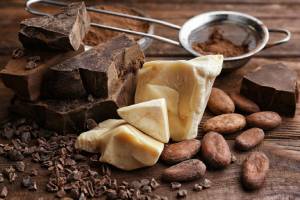collage of cocoa butter, cocoa powder, chocolate, coffee beans